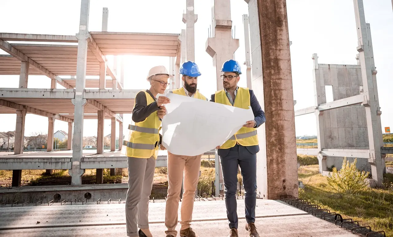 Zwei Fachleute besprechen einen Bauplan auf der Baustelle